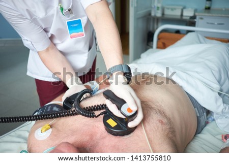 Doctor intensivist performs synchronized cardioversion to patient with AF