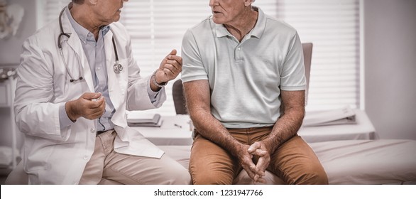 Doctor Interacting With Senior Patient In Clinic