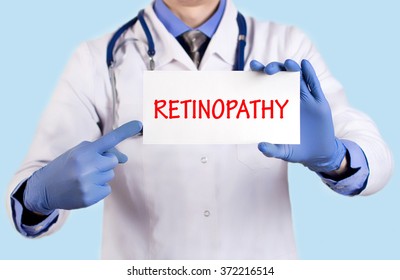 Doctor keeps a card with the name of the diagnosis - retinopathy. Selective focus. Medical concept.