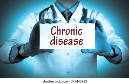 Doctor keeps a card with the name of the diagnosis - chronic disease. Selective focus. Medical concept.