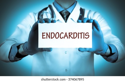 Doctor keeps a card with the name of the diagnosis - endocarditis. Selective focus. Medical concept.