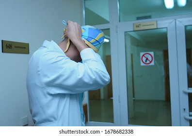 Doctor In The Lab Coat Puts Face Mask On Before Leaving Disinfection Post Of The Hospital