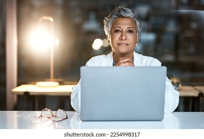 Doctor, laptop and portrait of senior woman in hospital working late or overtime on email, telehealth or research. Elderly, healthcare and confident female medical physician by computer at night. - Powered by Shutterstock