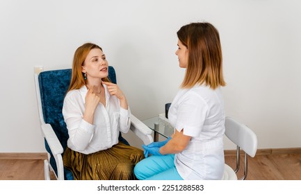 Doctor listening carefully. Beautician examining face skin of female patient. Consultation in cosmetology clinic. Female professional beauty doctor talking with pretty young female. - Shutterstock ID 2251288583