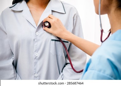 Doctor Listening To Patientâ??s Heartbeat With Stethoscope 
