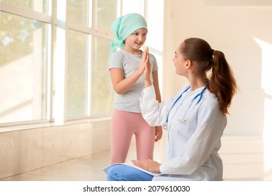 Doctor and little girl in clinic. Childhood cancer awareness concept - Shutterstock ID 2079610030