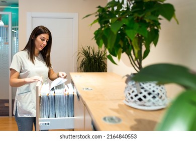 Doctor Looking For Files In Cabinet In Medical Center