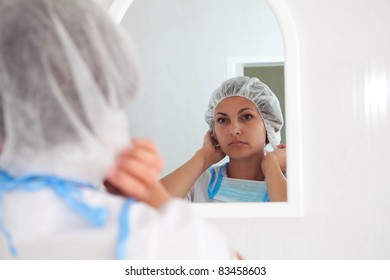 Doctor looking  in the mirror