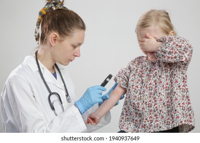 Doctor Looking At Red And Itchy Eczema On Little Girl's Arm. Toddler Girl Suffering From Atopic Dermatitis.