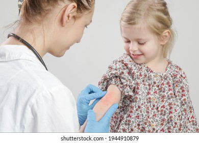 Doctor Looking At Red And Itchy Eczema On Little Girl's Arm. Toddler Girl Suffering From Atopic Dermatitis.	