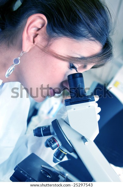 Doctor\
looking at samples under a microscope in a\
lab