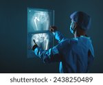 Doctor looking at total hip replacement X-ray film room at the hospital, healthcare concept.