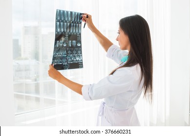 Doctor Looking At X-ray Or MRI Concept Healthcare, Medical And Radiology Concept.