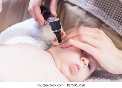 Doctor Looks Baby Ear With An Otoscope