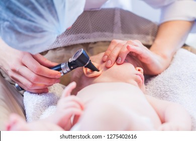 Doctor Looks Baby Ear With An Otoscope