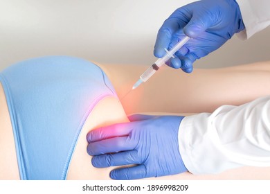 The Doctor Makes The Patient A Medication Blockade In The Area Of The Sciatic Nerve Buttocks. Concept Of A Complex Of Medicinal Products In A Drug Blockade To Eliminate Pain And Inflammation Of The