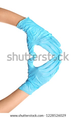 Doctor making heart shape with hands in medical gloves on white background