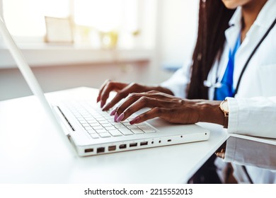 Doctor Making An Online Advise With Patient. Health Care In Modern Lifestyle. Woman Physician Prescribing Medication. Shot Of A Young Doctor Using A Laptop In A Hospital