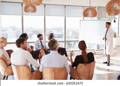 Doctor Making Presentation To Medical Staff In Hospital