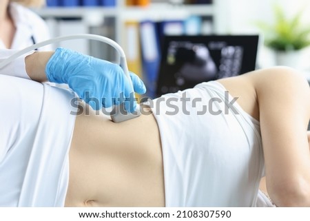 Doctor making ultrasound of kidneys to patient in clinic closeup