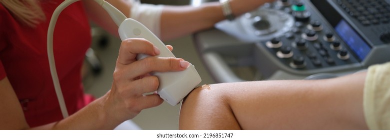 Doctor Making Ultrasound Of Patient Elbow Joint In Clinic Closeup. Instrumental Diagnosis Of Rheumatoid Arthritis Concept