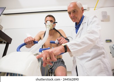 Doctor With Man Doing Fitness Test At The Medical Centre