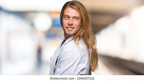 Doctor Man Looking Over The Shoulder With A Smile In A Hospital