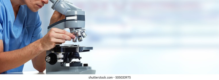 Doctor man with microscope.