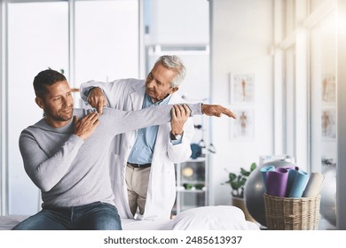 Doctor, man and patient with stretching for shoulder pain with physical therapy, healthcare or body recovery. Orthopedic, physician or medical expert for arm rehabilitation with examination or advice - Powered by Shutterstock