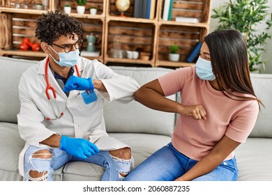 Doctor Man And Patient Woman Bump Elbow As A Protection Covid-19 Handshake.