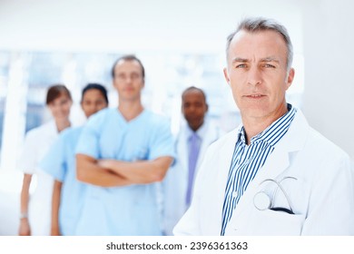 Doctor, man and portrait of expert with medical, healthcare and clinic staff in a hospital. Teamwork, leadership job and stethoscope of a nurse and surgeon with professional team ready for working - Powered by Shutterstock