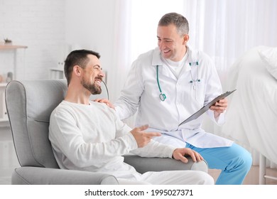 Doctor and man undergoing course of chemotherapy in clinic. Prostate cancer awareness concept