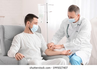 Doctor And Man Undergoing Course Of Chemotherapy In Clinic. Prostate Cancer Awareness Concept