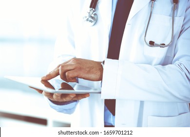 Doctor Man Using Tablet Computer For Network Research Or Virtual Disease Treatment, Hands Close-up. Perfect Medical Service In Clinic. Modern Medicine, Medic Data And Healthcare Concepts. Toned