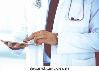 Doctor Man Using Tablet Computer For Network Research Or Virtual Disease Treatment, Hands Close-up. Perfect Medical Service In Clinic. Modern Medicine, Medic Data And Healthcare Concepts. Toned