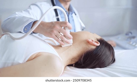 Doctor man is using ultrasound equipment on neck of female patient lying down for a medical examination. Medicine and science - Powered by Shutterstock