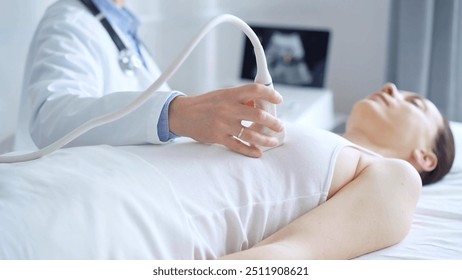 Doctor man using ultrasound equipment on the breast of a female patient. Female breast cancer prevention. mammary gland health. Medicine concept - Powered by Shutterstock