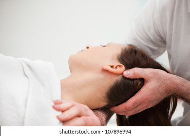 Doctor manipulating the neck of a woman in a room