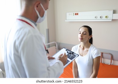 Doctor In Mask Communicates With Patient In Clinic . Ultrasound And Medical Diagnosis Concept