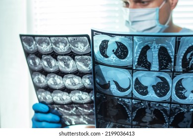 Doctor In Mask Examines And Compares Two MRI Scans.