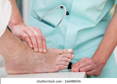 A Doctor Massaging A Patient's Ill Foot