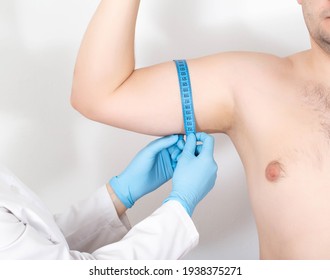 The Doctor Measures The Biceps Of A Man With A Measuring Tape To Increase The Biceps Using A Surgical Operation. Biceps Tendonitis