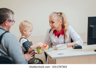 Doctor Measuring Blood Pressure Of A Child. Medical Equipment