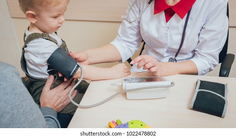 Doctor Measuring Blood Pressure Of A Child. Medical Equipment