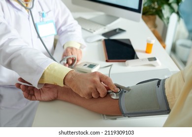 Doctor Measuring Blood Pressure Of Patient With Tonometer During Annual Checkup