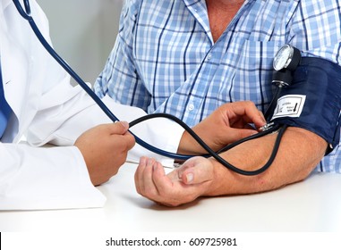Doctor measuring blood pressure with sphygmomanometer