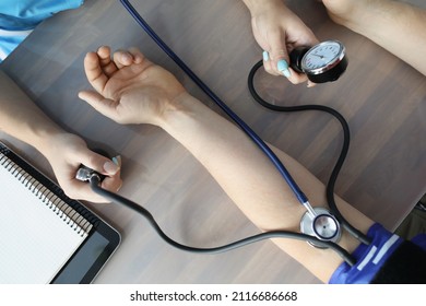 Doctor Measuring Blood Pressure With Tonometer At Table In Clinic Closeup