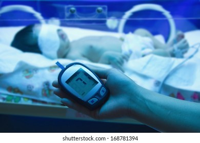 Doctor Measuring Glucose Level Blood Test From New Born Baby