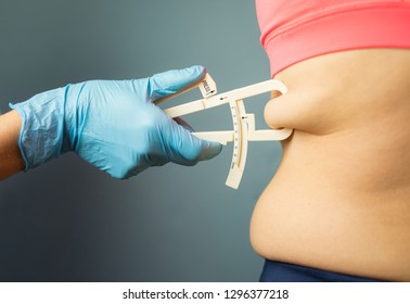 Doctor measuring patient's body fat