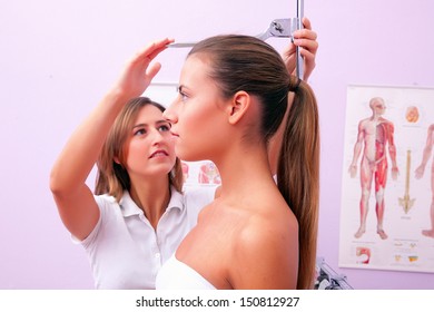 Doctor Measuring Patients Height